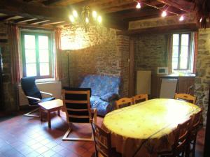 a room with a table and chairs and a couch at Riverside Retreat Viroinval in Treignes +95 photos