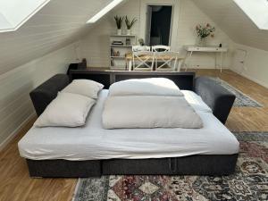 a bed with two pillows on it in a room at Stintebakken 1 in Arendal