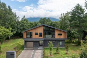 a house on a hill with a garage at Shion - 森音 in Kutchan