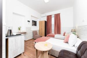 a living room with a bed and a table at Budget Hotel Rooms In Yerevan in Yerevan