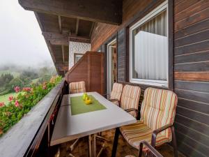a table and chairs on the balcony of a house at Apartment in Afritz near Ski Resorts in Afritz