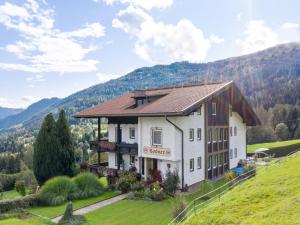 a building on a hill with mountains in the background at Apartment in Afritz near Ski Resorts in Afritz