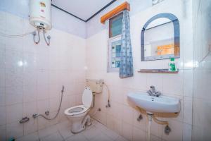 a bathroom with a toilet and a sink at Forest Rest House Barot in Barot 