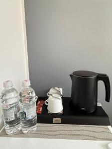 a coffee pot and two bottles of water on a tray at Olive Depadance in Mostar +12 photos