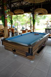a pool table sitting inside of a restaurant at Jungle Gili Air in Gili Islands