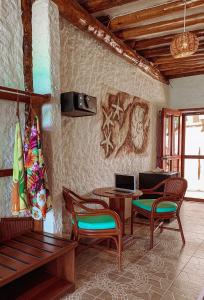 a living room with a table and chairs and a couch at Golden Paradise Oceanfront - Self Check in in Holbox Island
