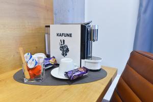 a table with a coffee maker and food on it at Villa Rosa in Timişoara
