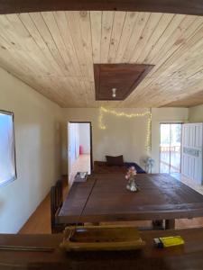 a large wooden table in a room with a ceiling at Teak Soul Home in Ban Na Toeng Nai
