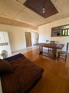 a living room with a table and a couch at Teak Soul Home in Ban Na Toeng Nai