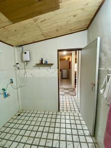 a bathroom with a walk in shower and a tile floor at Teak Soul Home in Ban Na Toeng Nai +8 photos