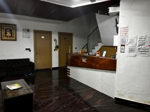 a restaurant with a counter in a room at Shri Radha Kripa Dham in Rādha Kund