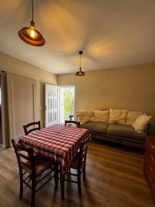 a living room with a table and a couch at Cascina Buren in Brescia