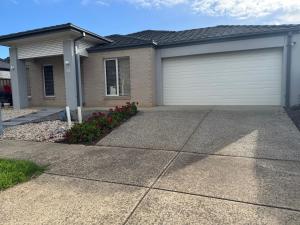 a house with a garage and a driveway at Quiet and Cozy Room in Geelong