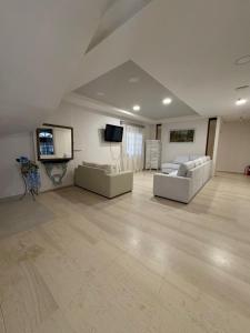 a large living room with two couches and a tv at Zakros Beach hotel in Tolo