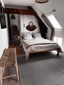 a bedroom with a king sized bed in a attic at La Cuvée , duplex à Gevrey Chambertin. in Gevrey-Chambertin