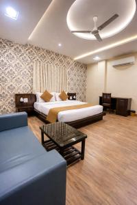 a hotel room with two beds and a couch at Veda Resort in Udaipur