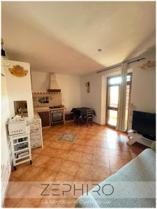 a large room with a living room with a table at Zephiro Guest House in La Maddalena