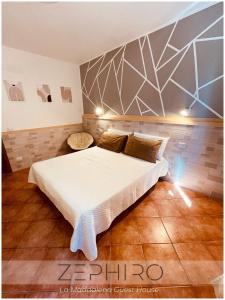 a bedroom with a large bed in a room at Zephiro Guest House in La Maddalena