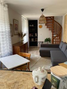 a living room with a couch and a table at La Cuvée , duplex à Gevrey Chambertin. in Gevrey-Chambertin