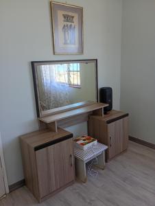 a room with a large mirror and wooden cabinets at Leisure Seaview House in Port Edward