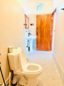 a bathroom with a toilet and a sink at Arugam Bay Holiday in Arugam Bay