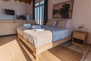a bedroom with a large bed and a couch at Modern Studio Loft in Central Larnaca with WiFi in Larnaca