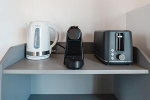 a shelf with a toaster and a blender on it at Modern Studio Loft in Central Larnaca with WiFi in Larnaca