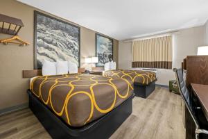 a hotel room with two beds in it at Super 8 by Wyndham Homewood Birmingham Area in Birmingham