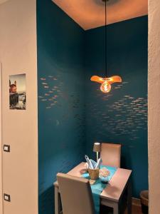 a dining room with a table and a blue wall at Affittacamere La Risacca in La Spezia +46 photos