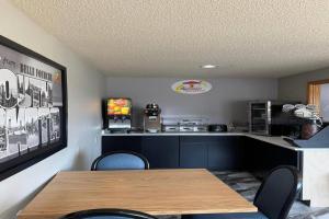 a fast food restaurant with a table and chairs at Super 8 by Wyndham Belle Fourche SD in Belle Fourche