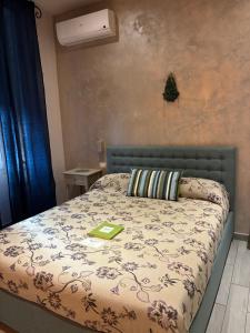 a bedroom with a bed with a green book on it at Affittacamere La Risacca in La Spezia