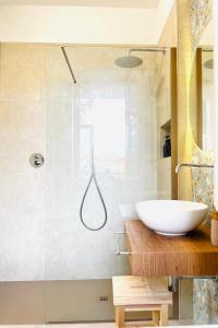 a bathroom with a white sink and a shower at La volpe e l'uva in Lavagno