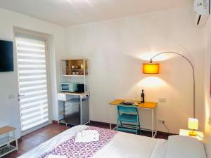 a bedroom with a bed and a desk and a table at La volpe e l'uva in Lavagno +8 photos