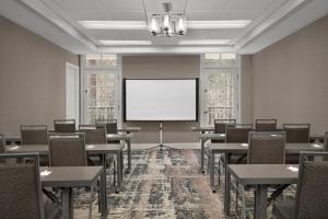 a conference room with tables and a white screen at Homewood Suites by Hilton Raleigh/Cary in Cary
