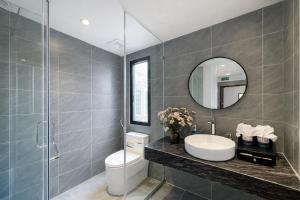 a bathroom with a toilet and a sink and a mirror at Hanora Boutique Hotel in Hanoi