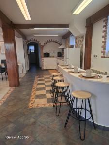 a kitchen with a counter and stools in a room at El Fumvial in Arnuero
