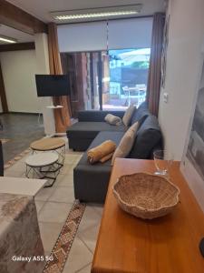 a living room with a blue couch and a table at El Fumvial in Arnuero