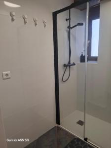 a shower with a glass door in a bathroom at El Fumvial in Arnuero +14 photos