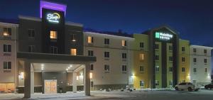 a large building with a sign on top of it at MainStay Suites Great Falls Airport in Great Falls