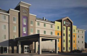 a building with a parking garage in front of it at MainStay Suites Great Falls Airport in Great Falls