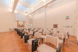 an empty room with chairs and a projection screen at Lolli Palace Hotel in Sanremo