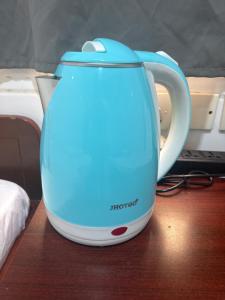 a blue and white tea kettle sitting on a table at Reliance Block C 12f in Hong Kong