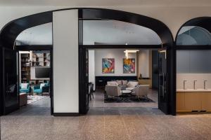 a lobby with a living room and a dining room at Tempo By Hilton Washington Dc Downtown in Washington, D.C.