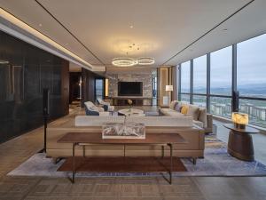 a living room with a couch and a table at Hilton Quzhou in Quzhou