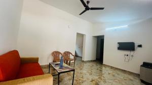 a living room with a couch and a tv at LX premium cottages - Udupi in Udupi +51 photos