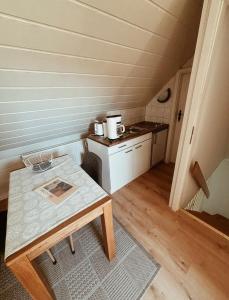 a small kitchen with a table in a room at Appartment, Ferienwohnung auf Fehmarn in Fehmarn