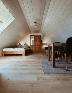 an attic room with a bed and a desk at Appartment, Ferienwohnung auf Fehmarn in Fehmarn