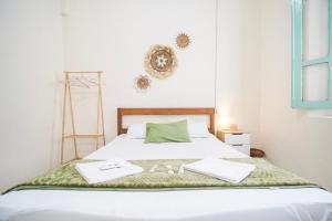 a bedroom with a bed with two towels on it at Homestay Putri Kencono in Yogyakarta