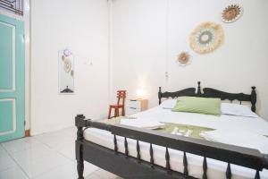 a bedroom with a bed and a blue door at Homestay Putri Kencono in Yogyakarta +25 photos