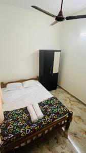 a bedroom with a bed with two towels on it at LX premium cottages - Udupi in Udupi